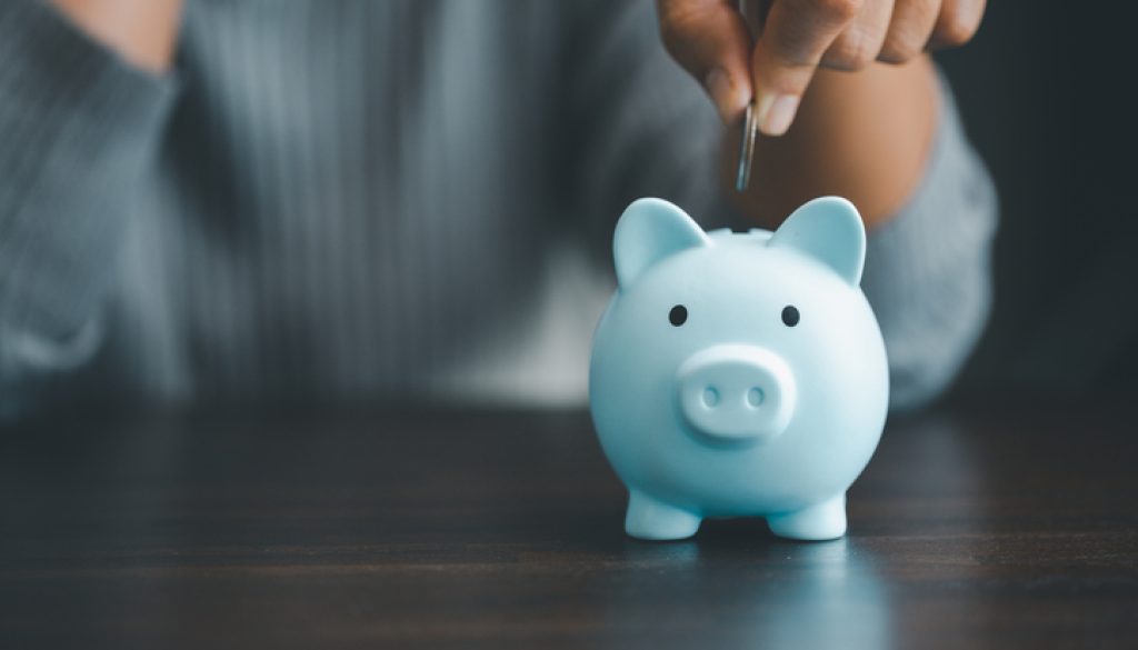 Saving investment banking finance concept. Stack of coins with piggy bank on the table. Growth of loan and investment business idea. Asset Management, Funds, Liabilities, Deposits, Income, Successful.